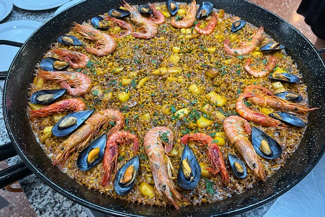 Seafood paella cooking class, tapas and visit to Ruzafa market. - Eating what you cooked: tomato salad, wines, dessert, coffee, mistela